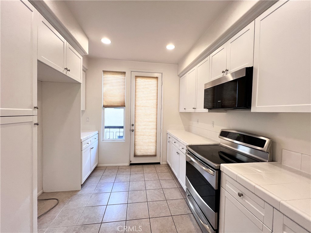 58 South 5th Street, Unit F Alhambra, CA 91801 - Photo 10 of 24 a kitchen with a sink a stove and cabinets