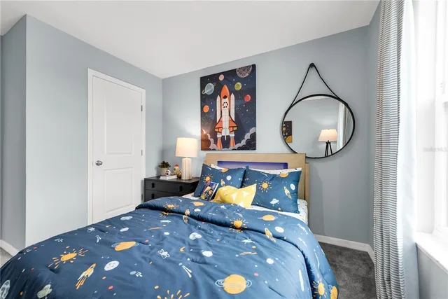 a bedroom with a bed and a chandelier