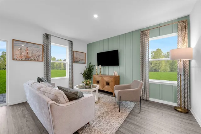 a living room with furniture and a view of kitchen