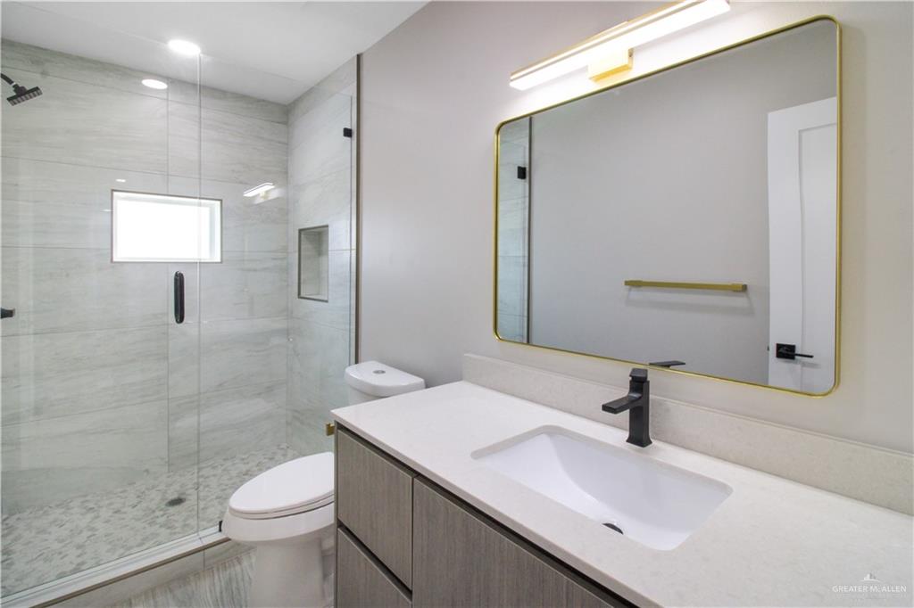 3429 May Street Mission, TX 78573 - Photo 11 of 16 a bathroom with a sink a toilet and shower