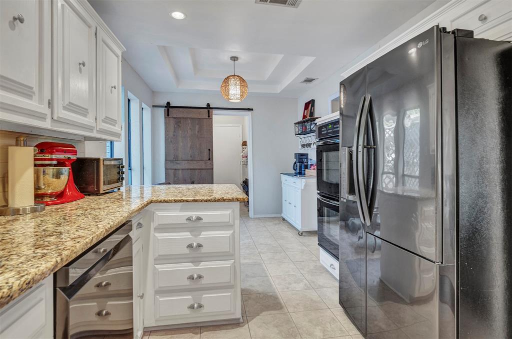 2317 Daybreak Trail Plano, TX 75093 - Photo 11 of 29 a kitchen with stainless steel appliances granite countertop a refrigerator and cabinets