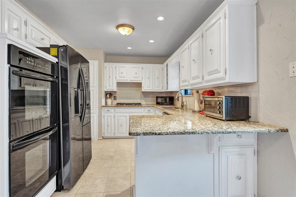 2317 Daybreak Trail Plano, TX 75093 - Photo 12 of 29 a kitchen with stainless steel appliances granite countertop a refrigerator sink and stove