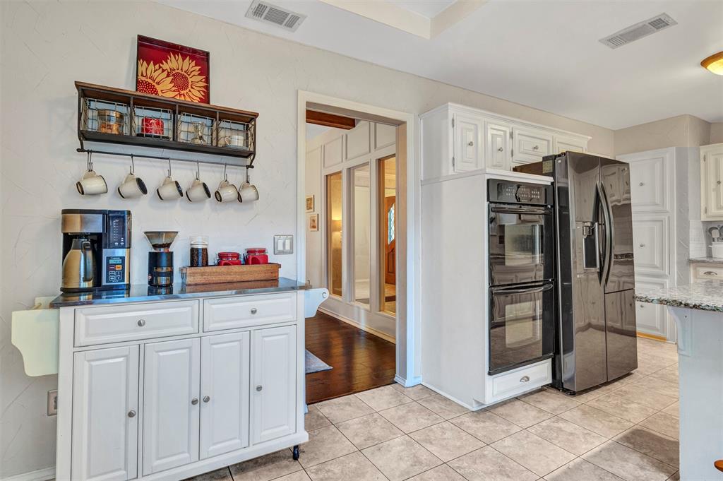2317 Daybreak Trail Plano, TX 75093 - Photo 13 of 29 a kitchen with stainless steel appliances a refrigerator and cabinets
