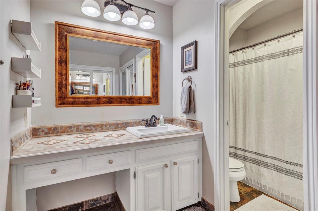 2317 Daybreak Trail Plano, TX 75093 - Photo 16 of 29 a bathroom with a sink a vanity and a mirror