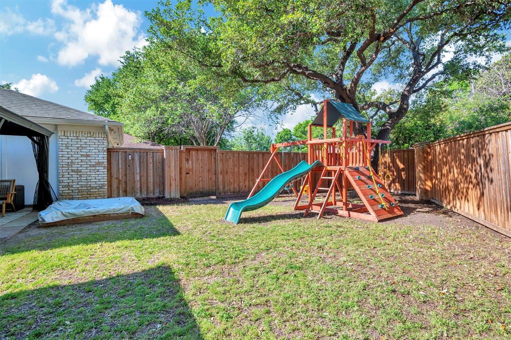 2317 Daybreak Trail Plano, TX 75093 - Photo 24 of 29 a view of a backyard with a slide