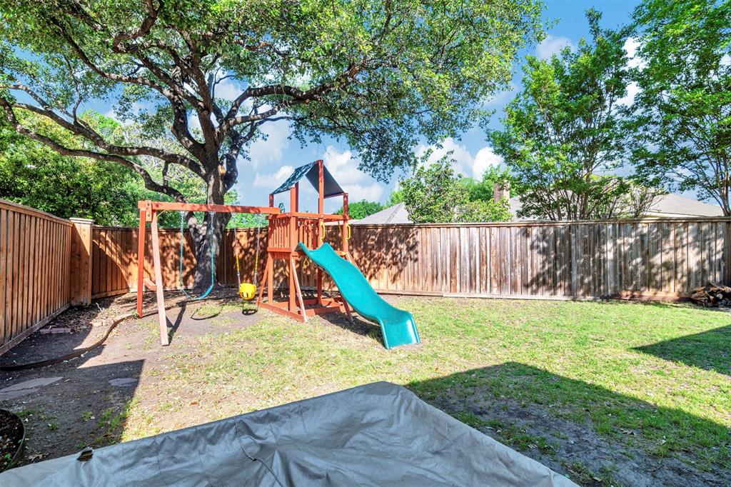 2317 Daybreak Trail Plano, TX 75093 - Photo 25 of 29 a park with large trees and a wooden fence