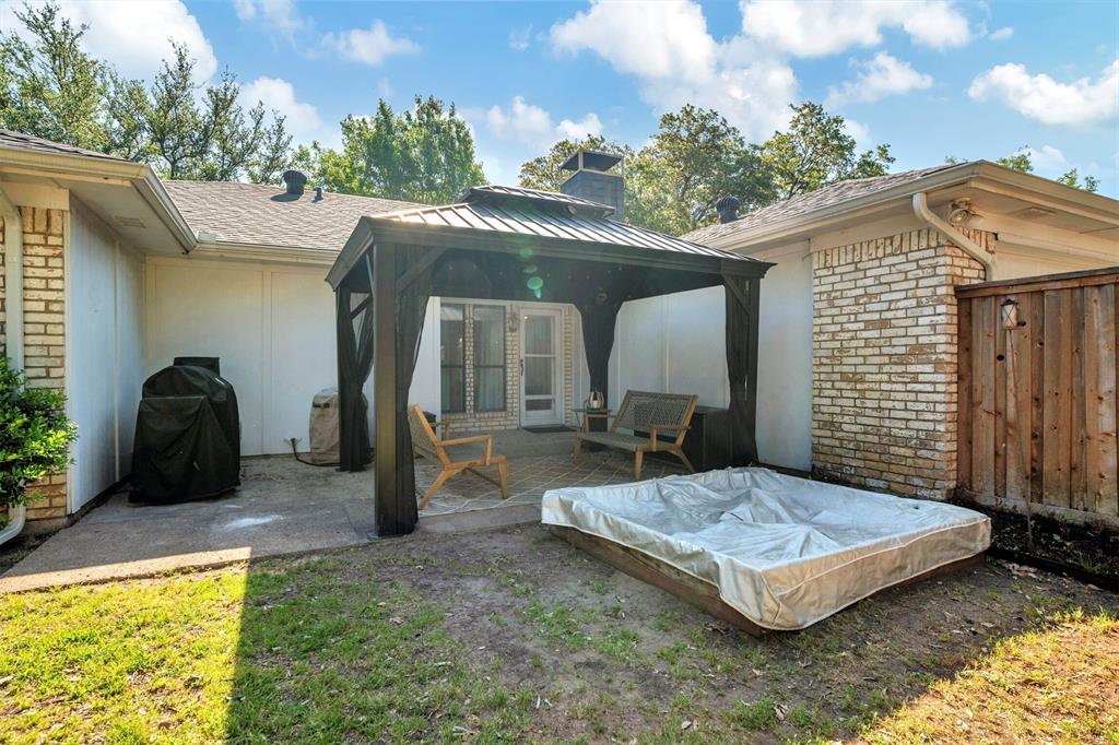 2317 Daybreak Trail Plano, TX 75093 - Photo 27 of 29 a spacious bedroom with a bed and a chandelier