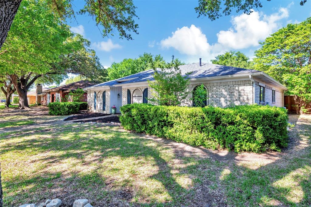 2317 Daybreak Trail Plano, TX 75093 - Photo 29 of 29 a front view of a house with a yard and a garden