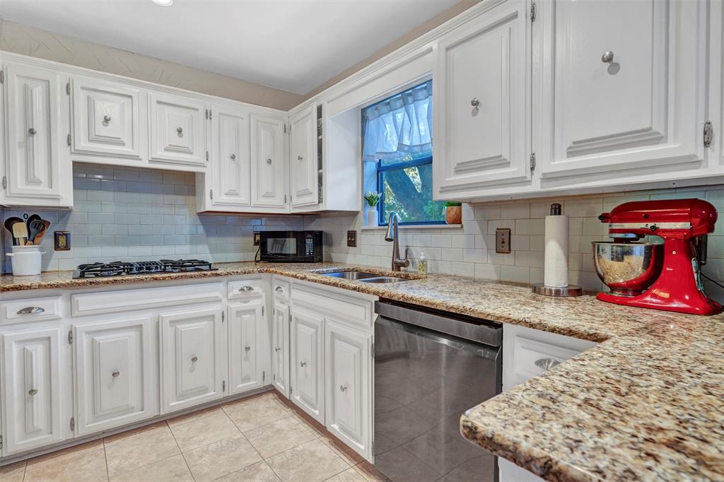 2317 Daybreak Trail Plano, TX 75093 - Photo 9 of 29 a kitchen with stainless steel appliances granite countertop a stove sink and cabinets