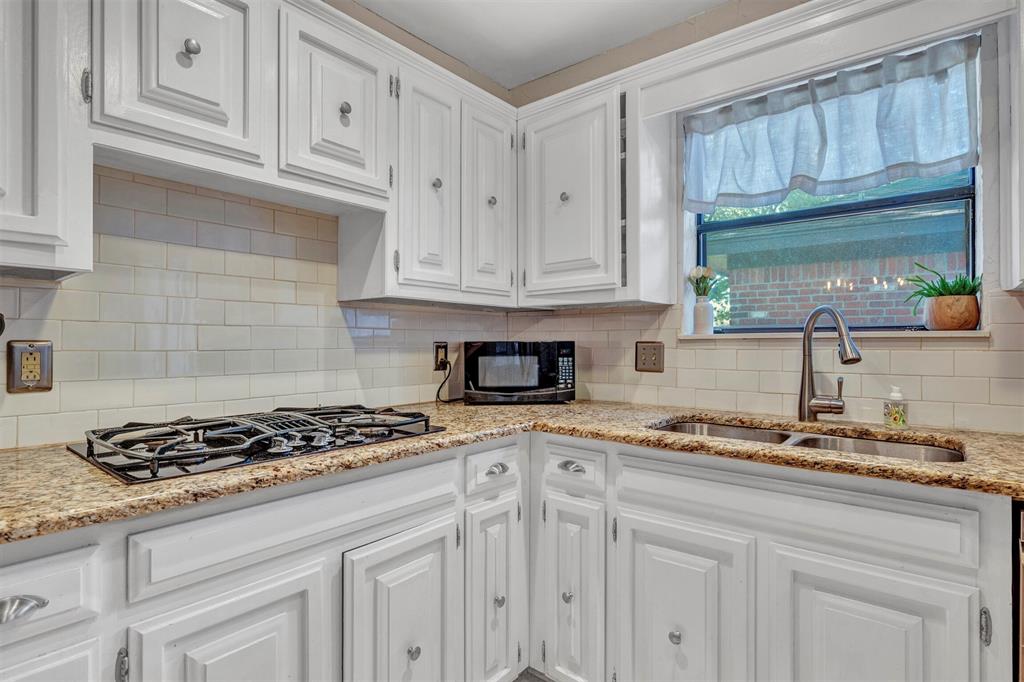 2317 Daybreak Trail Plano, TX 75093 - Photo 10 of 29 a kitchen with granite countertop cabinets and window