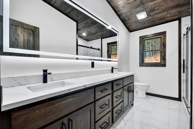 a bathroom with a double vanity sink and a mirror