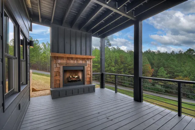 a view of a balcony with a fireplace and wooden floor