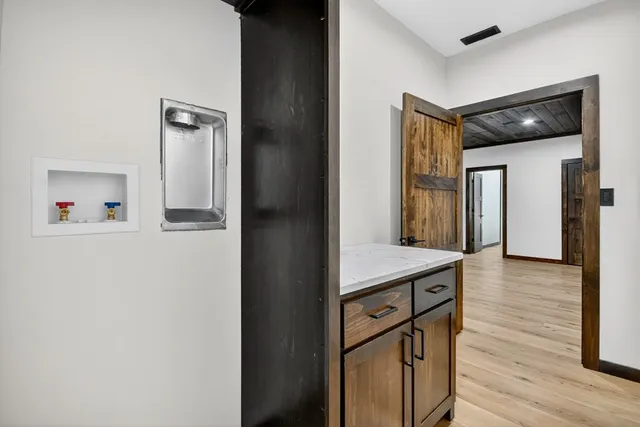 a view of kitchen with cabinets and wooden floor