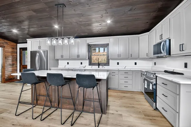 a kitchen with cabinets and chairs