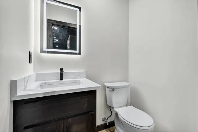 a white toilet sitting next to a bathroom sink