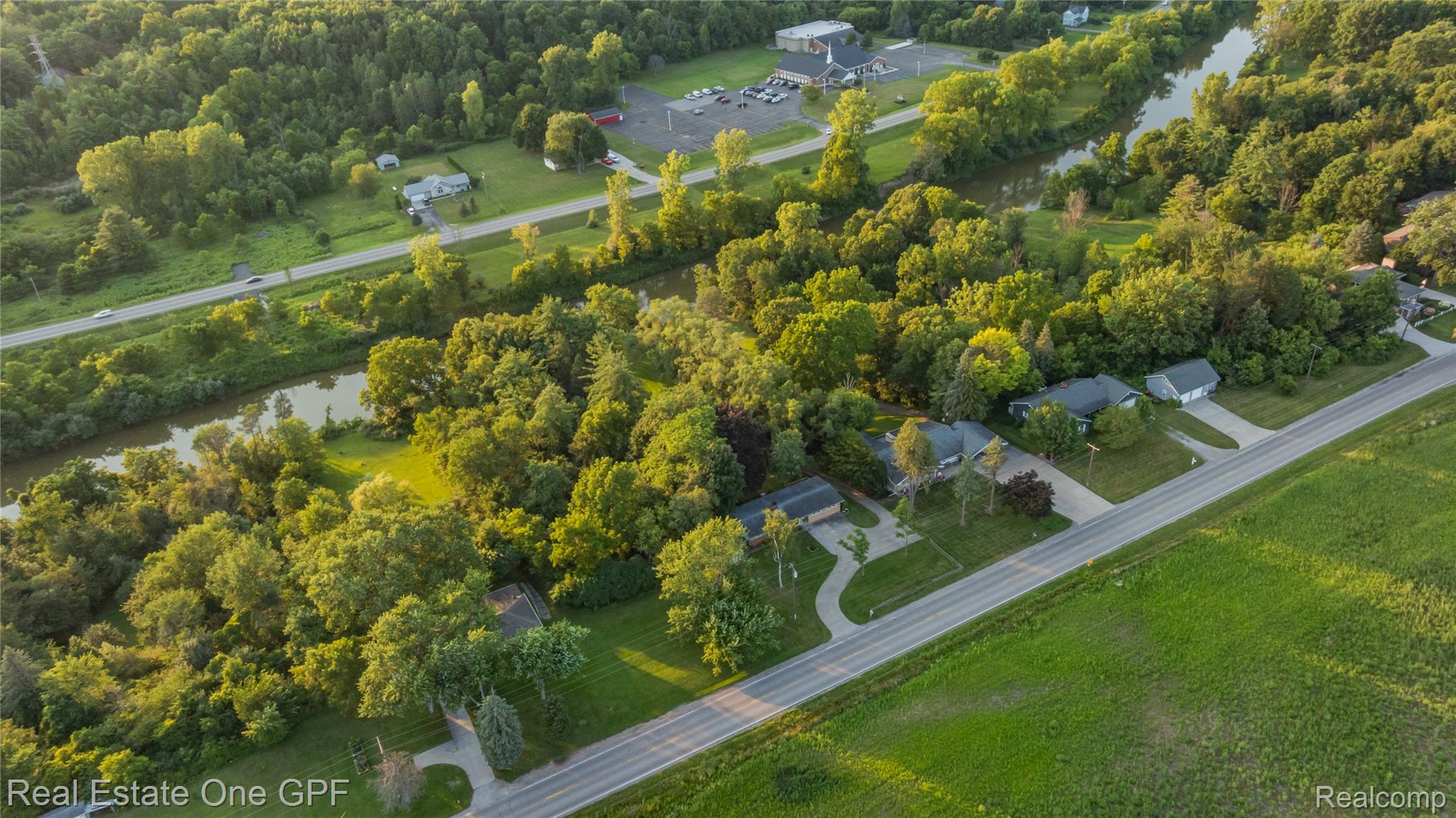 5068 Atkins Road North Street, MI 48049 - Photo 69 of 78 Riverfront property with mature trees, green space, and private driveways