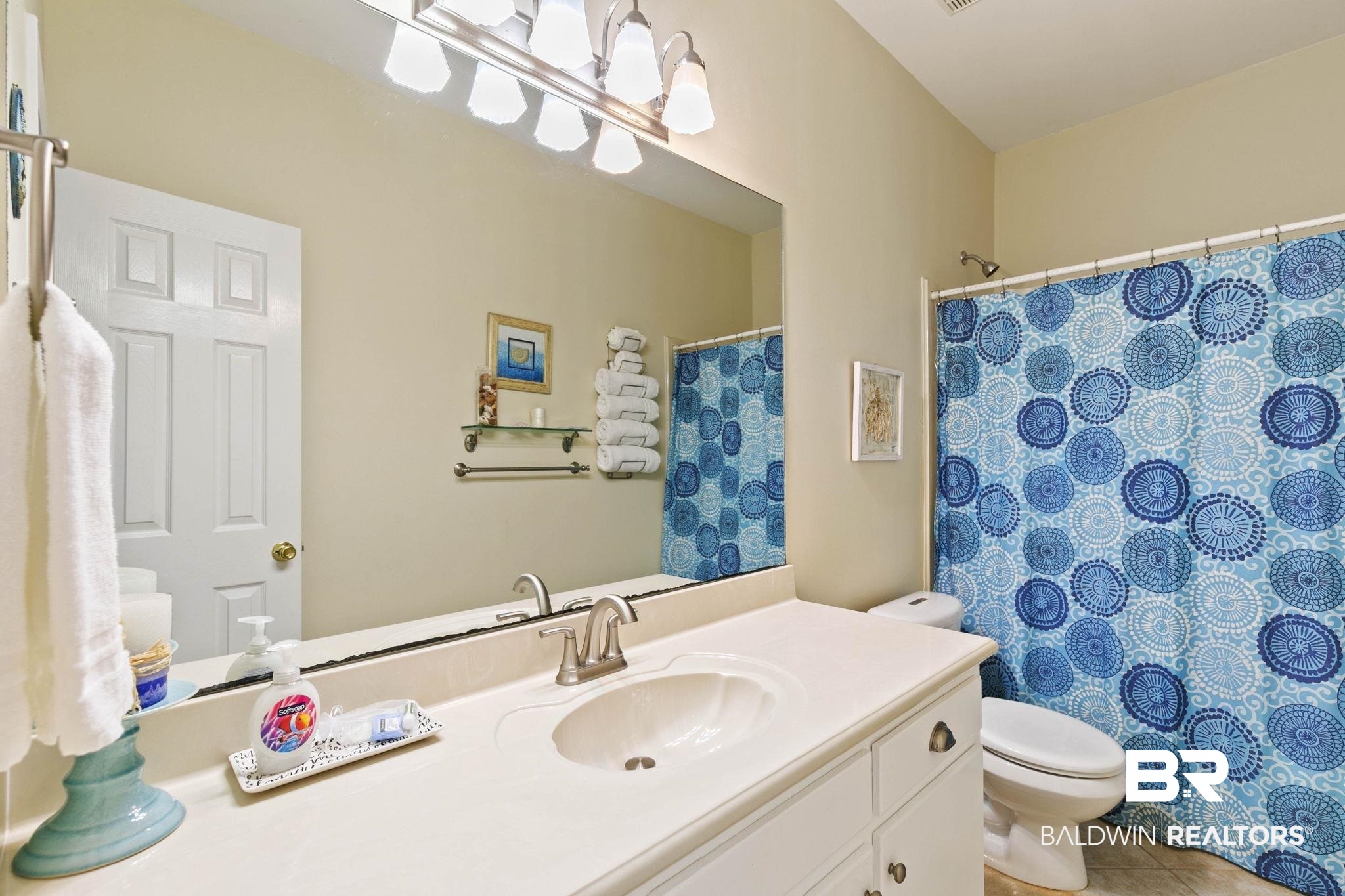 6802 Shore Drive Elberta, AL 36530 - Photo 21 of 34 Bathroom featuring an expansive vanity with an integrated sink, brushed nickel faucet, and overhead vanity lighting