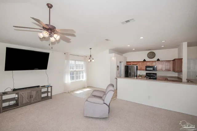a living room with furniture and kitchen view