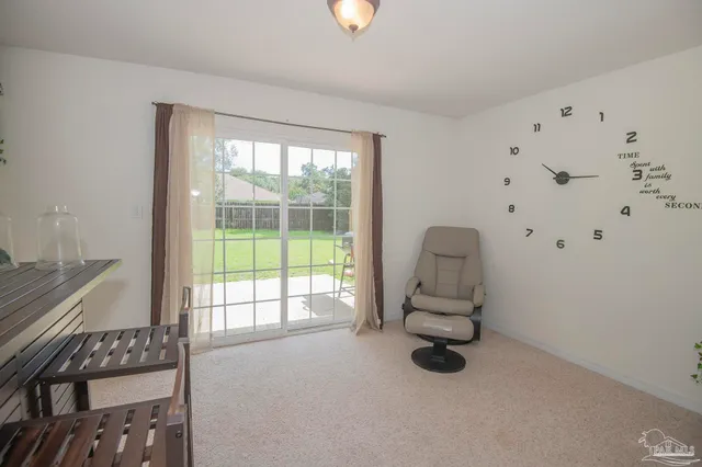 a view of a dining room with furniture and a chandelier