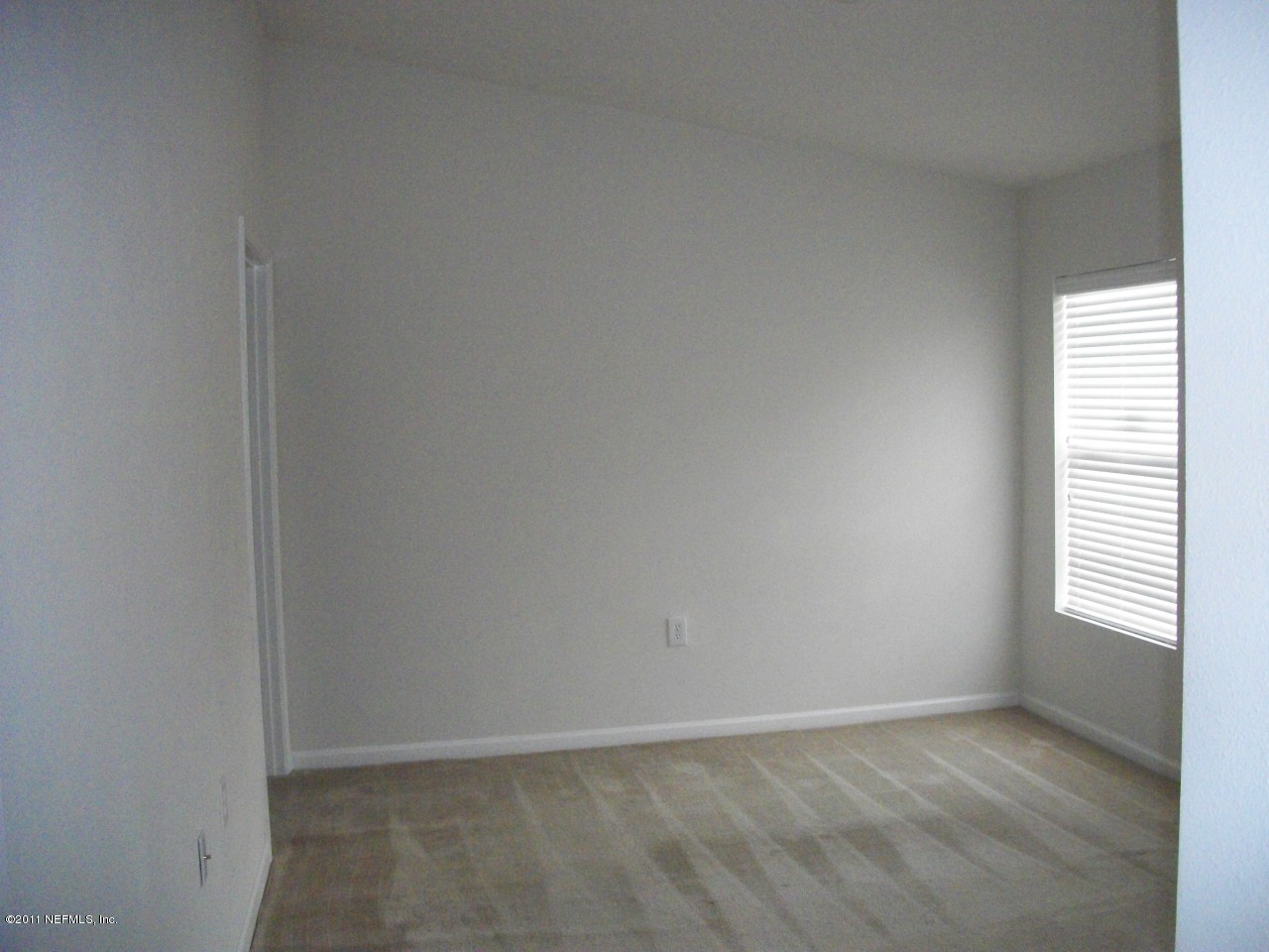 7920 Merrill Road, Unit 1511 Jacksonville, FL 32277 - Photo 6 of 11 a view of an empty room with a window