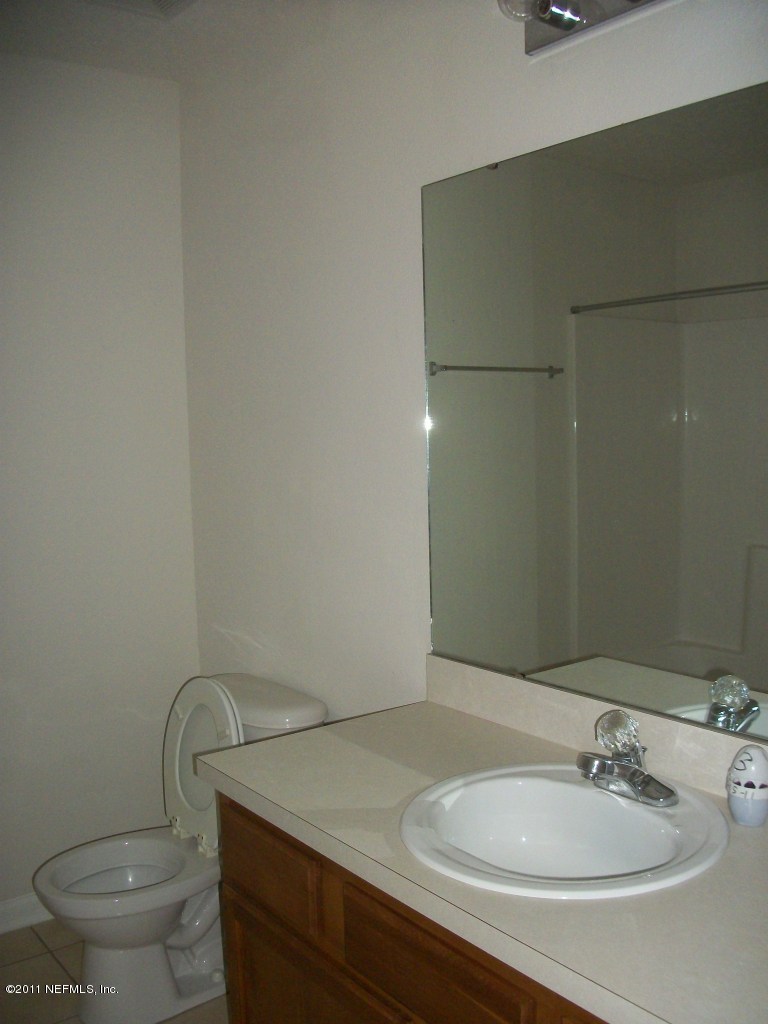 7920 Merrill Road, Unit 1511 Jacksonville, FL 32277 - Photo 7 of 11 a bathroom with a sink and a mirror
