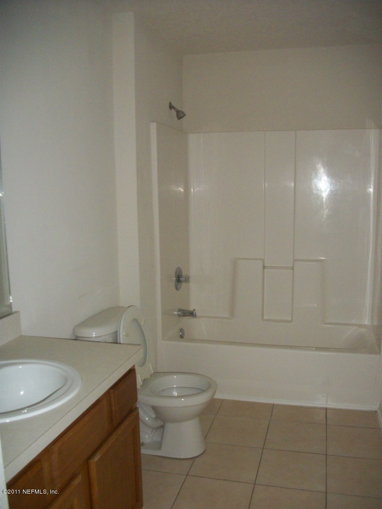 7920 Merrill Road, Unit 1511 Jacksonville, FL 32277 - Photo 8 of 11 a bathroom with a sink a toilet and shower