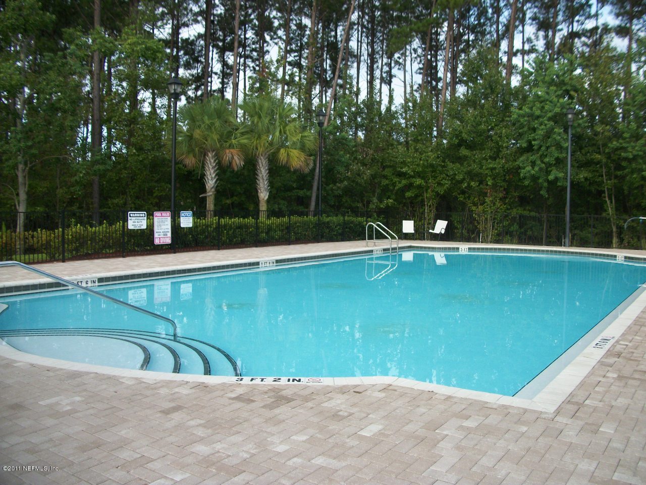 7920 Merrill Road, Unit 1511 Jacksonville, FL 32277 - Photo 9 of 11 a view of a swimming pool with a yard