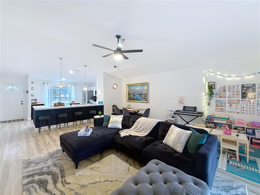 14908 Southwest 46th Circle Ocala, FL 34473 - Photo 14 of 46 a living room with furniture a rug and a chandelier