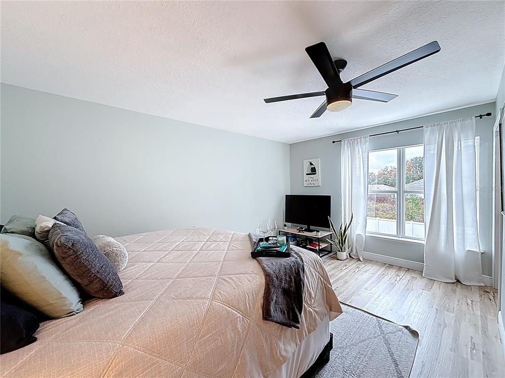 14908 Southwest 46th Circle Ocala, FL 34473 - Photo 15 of 46 a bedroom with a large bed and a flat screen tv