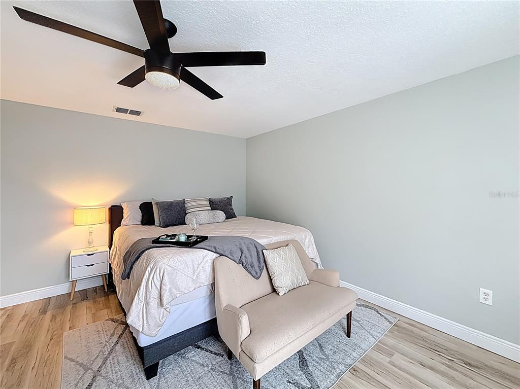 14908 Southwest 46th Circle Ocala, FL 34473 - Photo 17 of 46 a bedroom with a bed and a ceiling fan