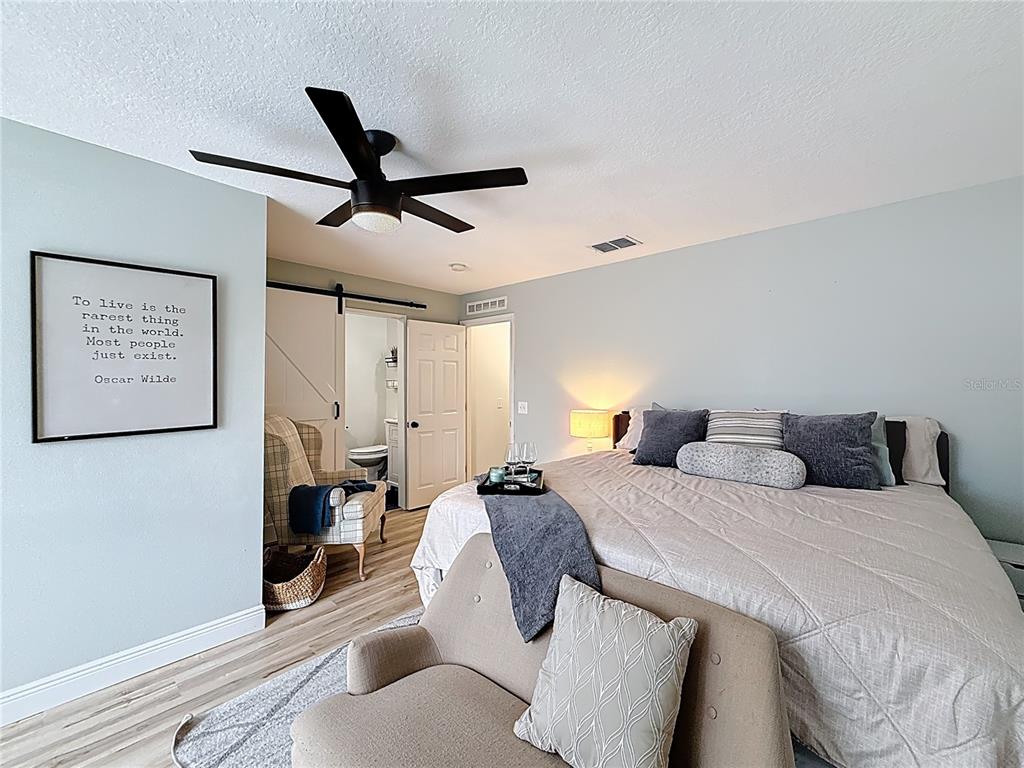 14908 Southwest 46th Circle Ocala, FL 34473 - Photo 18 of 46 a bedroom with a bed and wooden floor
