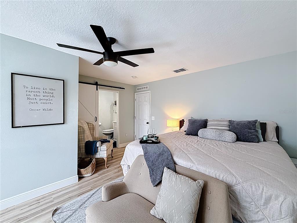 14908 Southwest 46th Circle Ocala, FL 34473 - Photo 19 of 46 a bedroom with a bed and painting on the wall