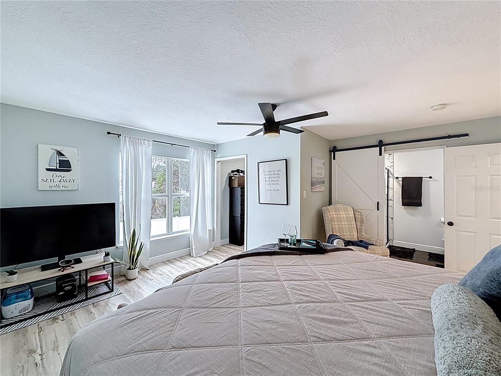 14908 Southwest 46th Circle Ocala, FL 34473 - Photo 20 of 46 a bedroom with furniture and a flat screen tv