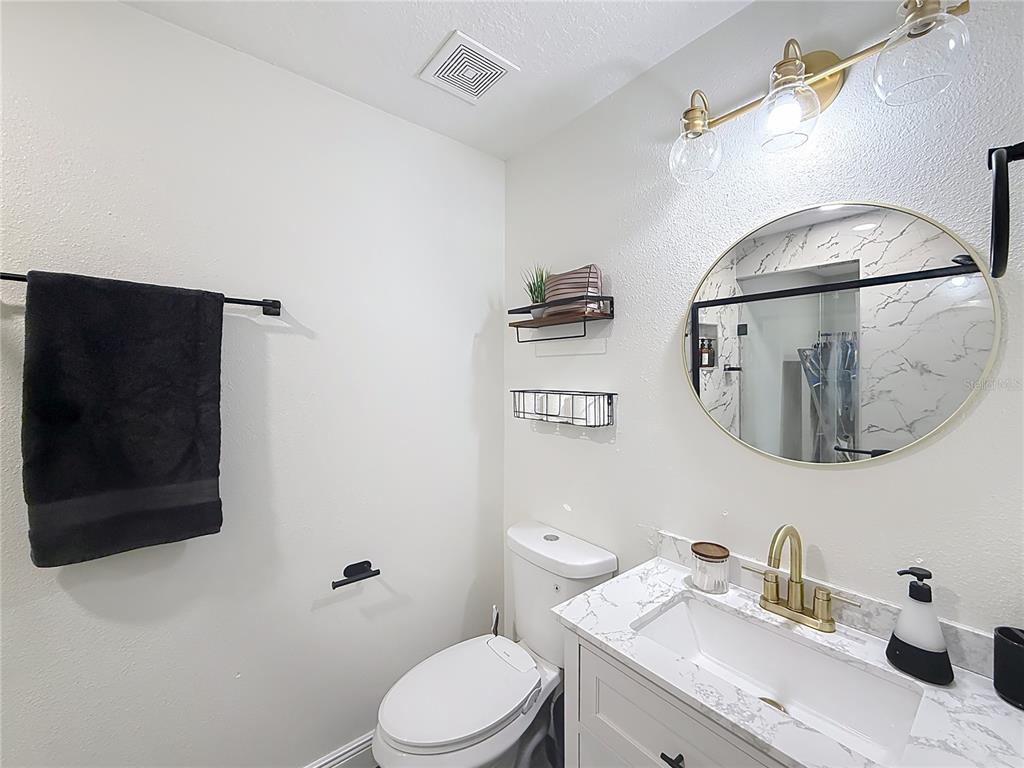 14908 Southwest 46th Circle Ocala, FL 34473 - Photo 21 of 46 a bathroom with a toilet a sink and mirror