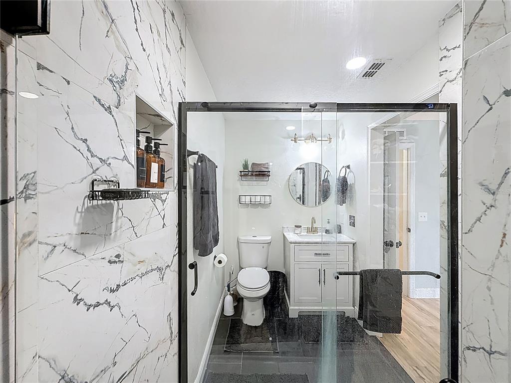 14908 Southwest 46th Circle Ocala, FL 34473 - Photo 23 of 46 a bathroom with a glass shower door