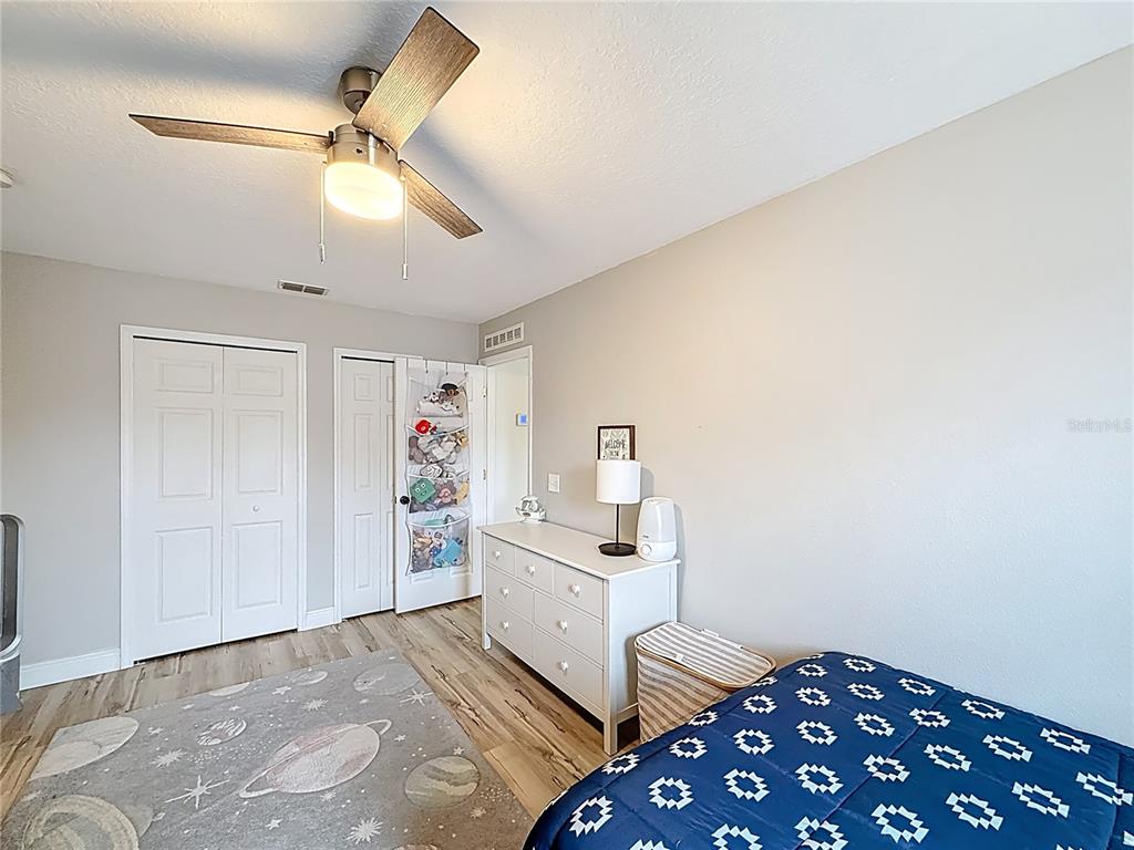 14908 Southwest 46th Circle Ocala, FL 34473 - Photo 24 of 46 a bedroom with a bed and a chandelier