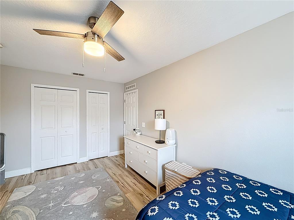14908 Southwest 46th Circle Ocala, FL 34473 - Photo 25 of 46 a bedroom with a bed and a chandelier