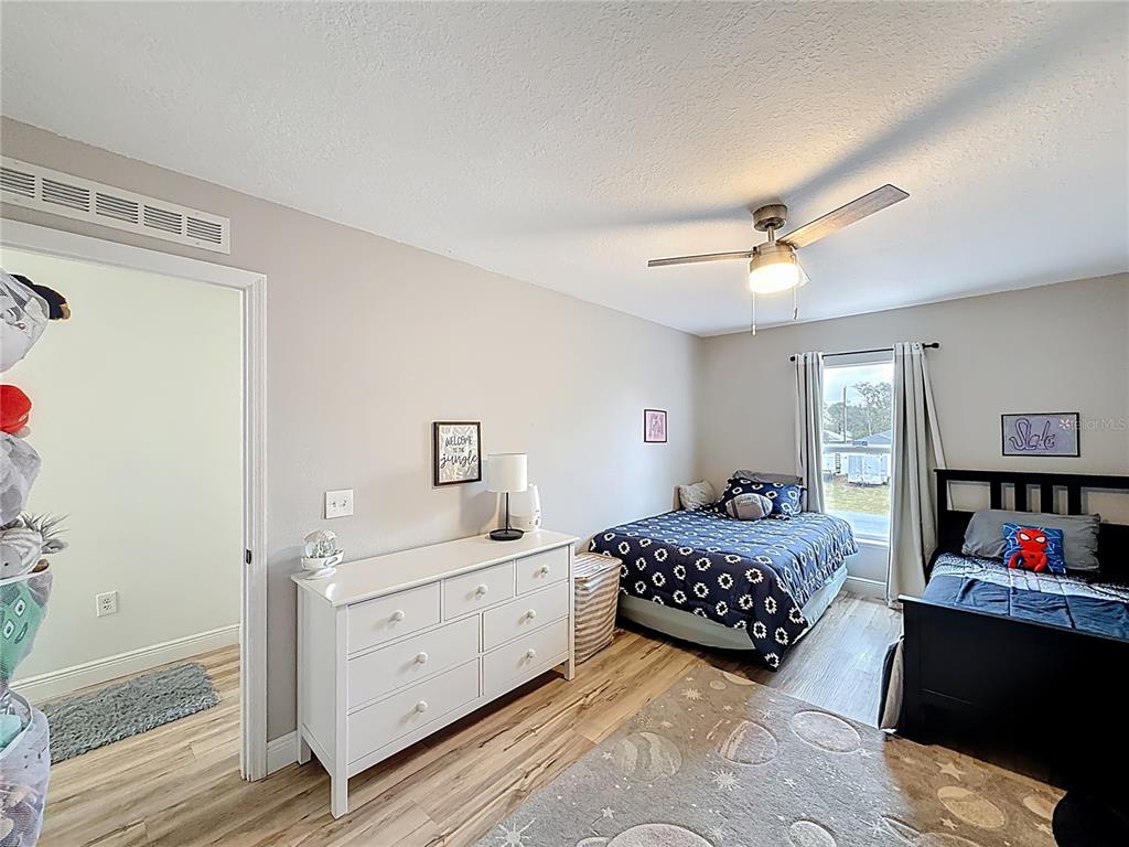 14908 Southwest 46th Circle Ocala, FL 34473 - Photo 26 of 46 a bedroom with a bed a dresser and book shelf