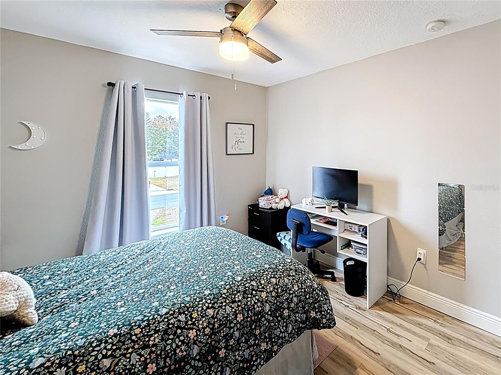14908 Southwest 46th Circle Ocala, FL 34473 - Photo 28 of 46 a bedroom with a bed and a flat screen tv