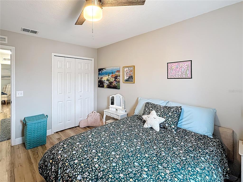 14908 Southwest 46th Circle Ocala, FL 34473 - Photo 30 of 46 a bedroom with a bed and a chandelier