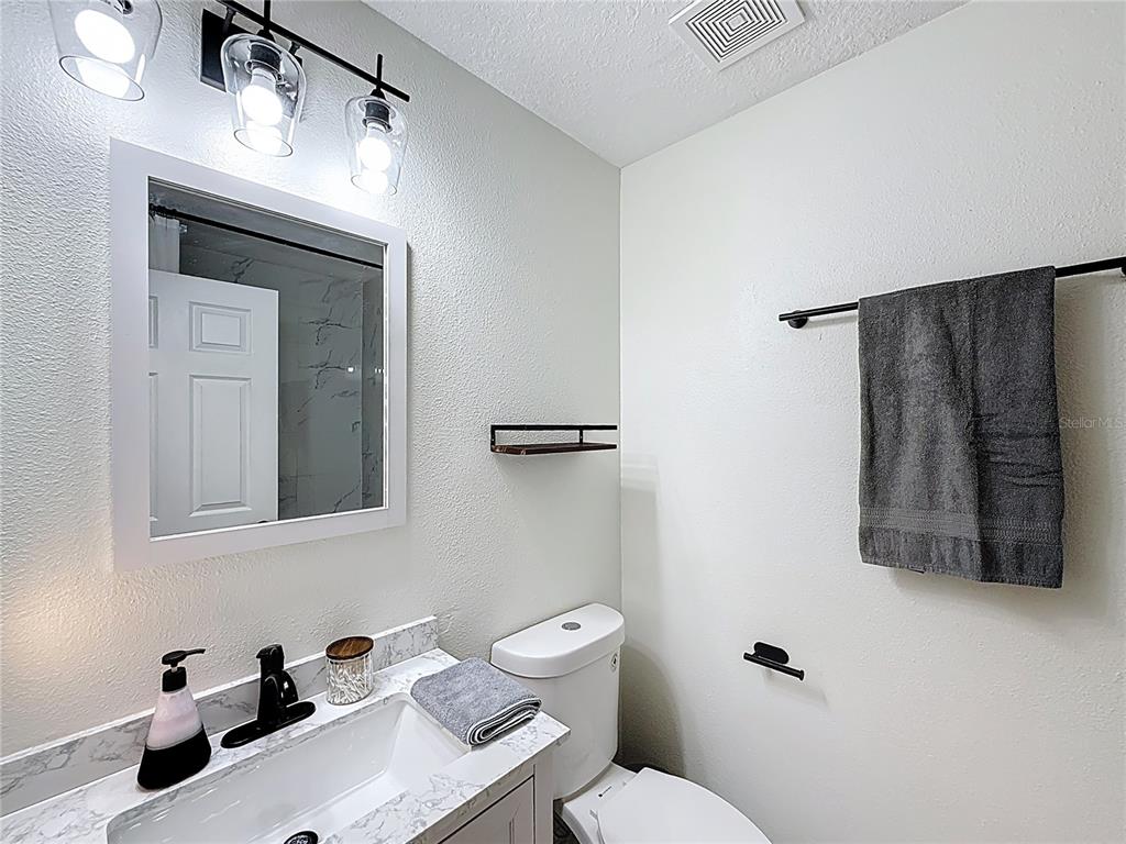 14908 Southwest 46th Circle Ocala, FL 34473 - Photo 31 of 46 a bathroom with a sink a toilet and mirror