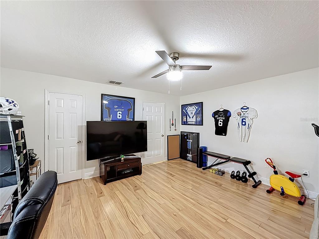 14908 Southwest 46th Circle Ocala, FL 34473 - Photo 34 of 46 a bedroom with a bed and a flat screen tv