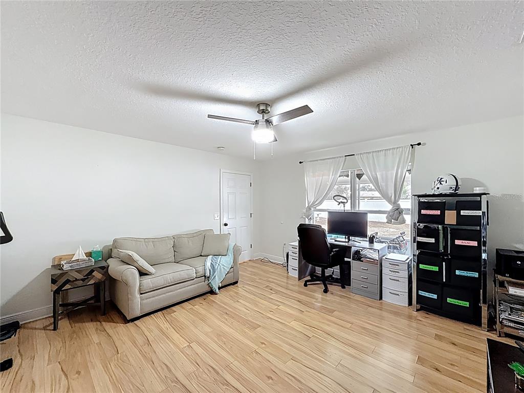 14908 Southwest 46th Circle Ocala, FL 34473 - Photo 36 of 46 a living room with furniture and wooden floor