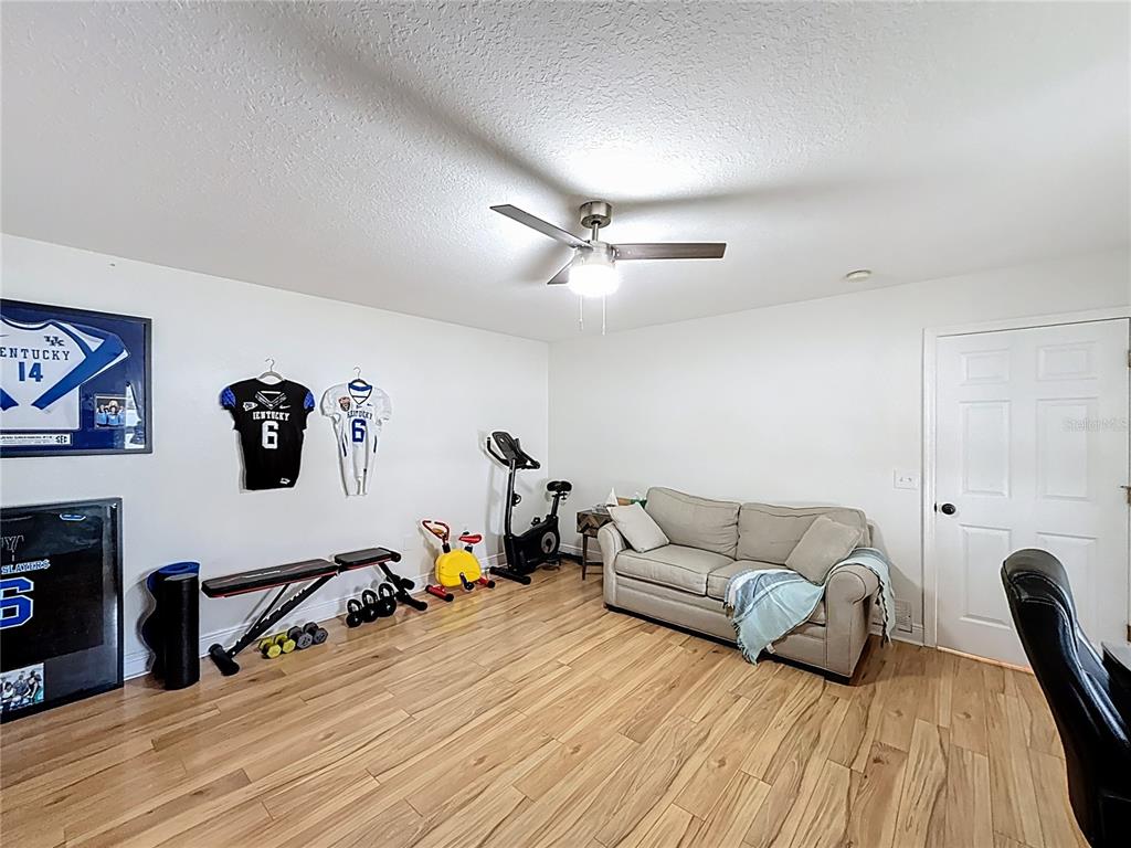 14908 Southwest 46th Circle Ocala, FL 34473 - Photo 37 of 46 a living room with furniture and a flat screen tv