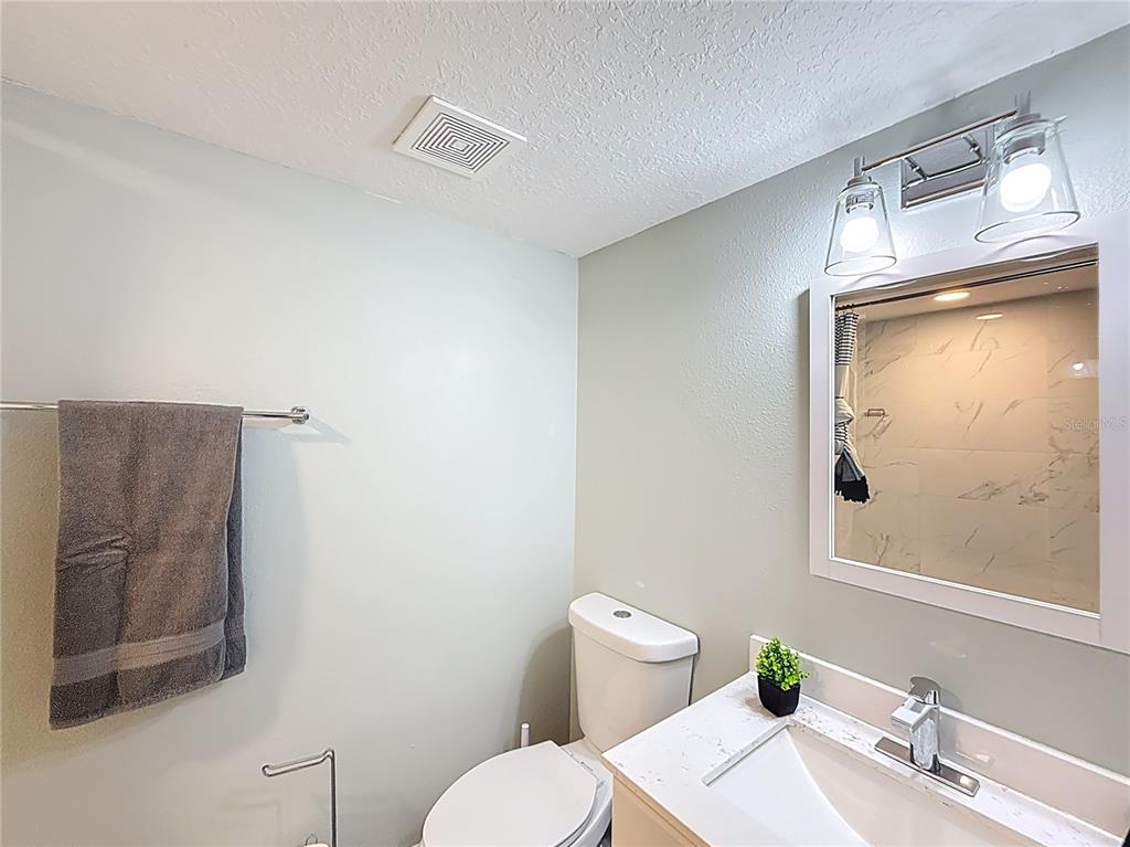 14908 Southwest 46th Circle Ocala, FL 34473 - Photo 38 of 46 a bathroom with a granite countertop sink mirror vanity and toilet