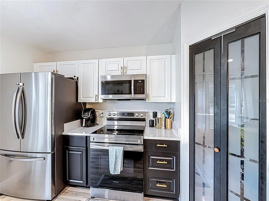 14908 Southwest 46th Circle Ocala, FL 34473 - Photo 9 of 46 a kitchen with stainless steel appliances a refrigerator stove and microwave