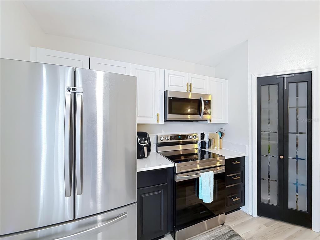 14908 Southwest 46th Circle Ocala, FL 34473 - Photo 10 of 46 a kitchen with a refrigerator stove and microwave