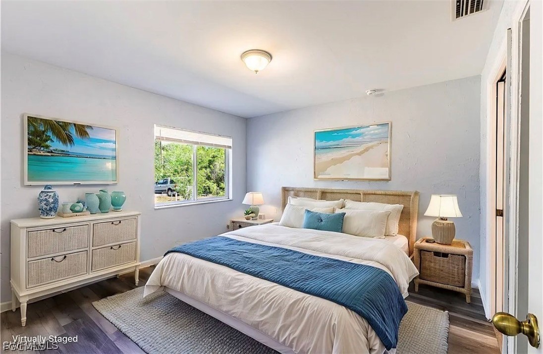 4716 1st Street Southwest Lehigh Acres, FL 33973 - Photo 11 of 20 a bedroom with a large bed and a window