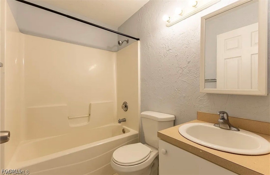 4716 1st Street Southwest Lehigh Acres, FL 33973 - Photo 16 of 20 a bathroom with a sink toilet and shower