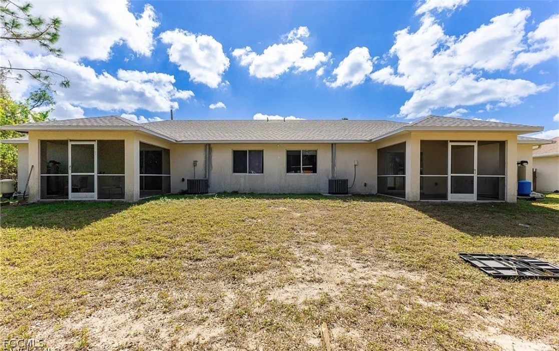 4716 1st Street Southwest Lehigh Acres, FL 33973 - Photo 18 of 20 a view of a house with a yard